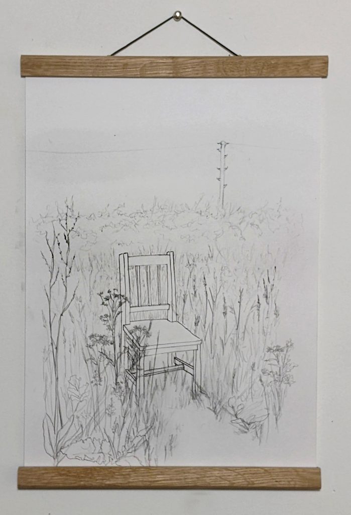 A pencil drawing features a wooden dining chair in a meadow surrounded by wild flowers and grasses. In the distance is a telegraph pole and its cables.